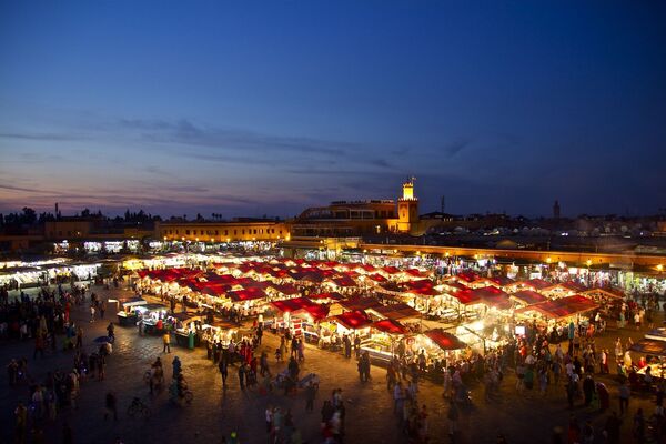 Busy market, lit up at night time.