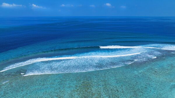 The soft wave water of the sea on the sandy beach background