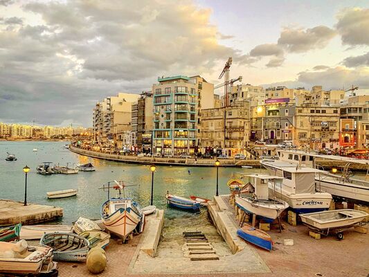 St. Julian’s, Malta - March 12, 2023:  An evening view across Spinola Bay on the Mediterranean island of Malta.