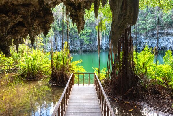 Three eyes cave in Santo Domingo, los Tres Ojos national park, Dominican Republic. Scenic view of limestone cave, beautiful lake and tropical plants, nature landscape, outdoor travel background