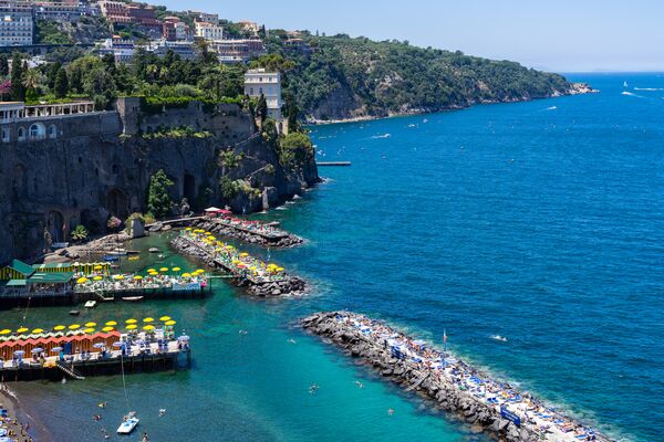 A landscape of Villa Comunale surrounded by the sea under the sunlight in Sorrento, Italy