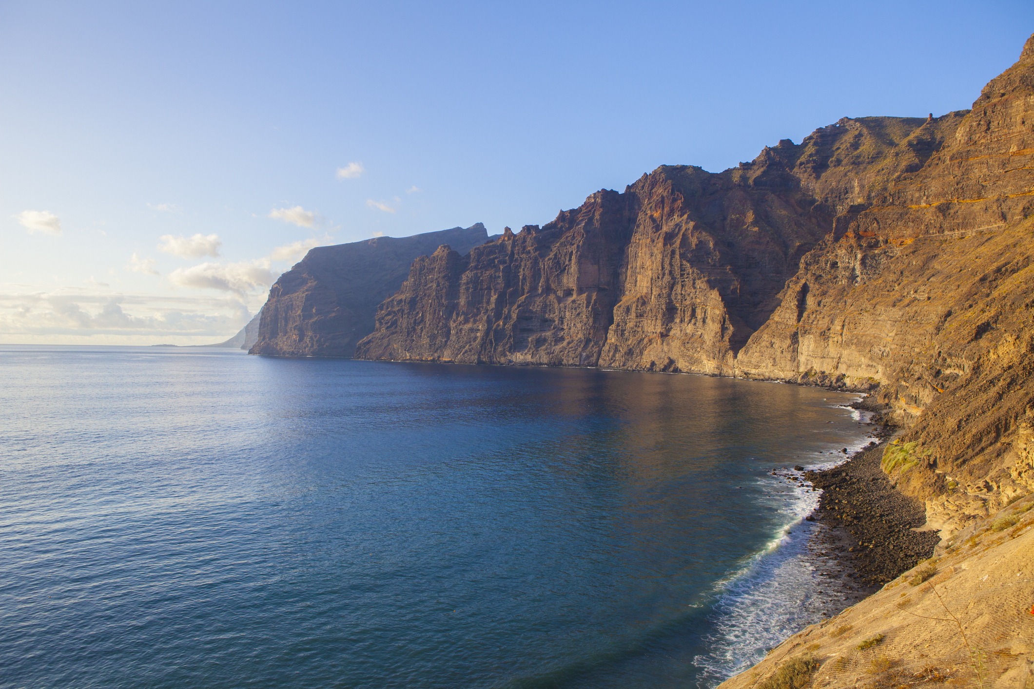 Acantilados de los Gigantes, giant's cliffs in Tenerife Island. South western part of the island with amazing basalt walls that ends in the ocean. Sunny afternoon with calm waters.